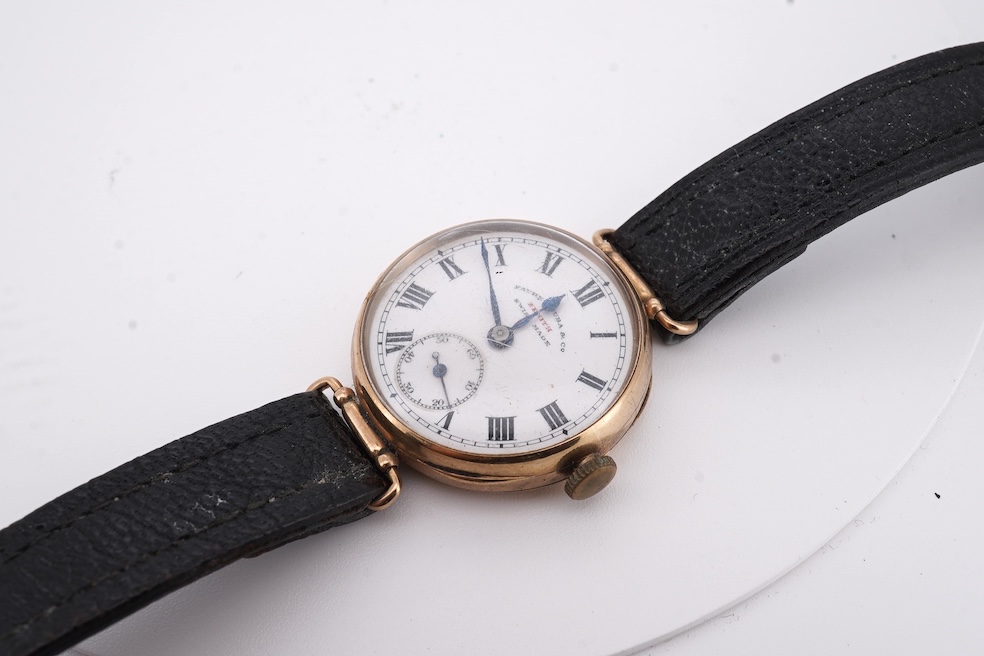 An early 20th century 9ct gold Zenith manual wind wrist watch, retailed by Favre Leuba, with Roman dial and subsidiary seconds, case diameter 28mm, on an associated leather strap. Condition - poor to fair
